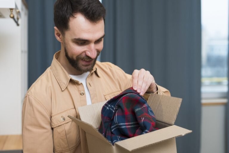 Man unboxing a shirt from a delivery box