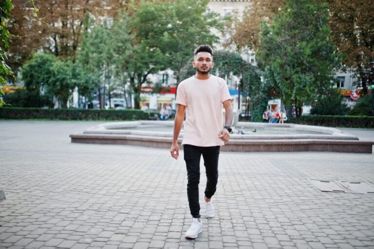Man wearing a T-shirt and sneakers outdoors