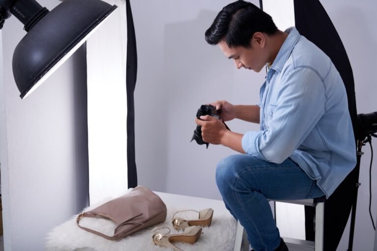 Photographer shooting a bag and sandals in a studio