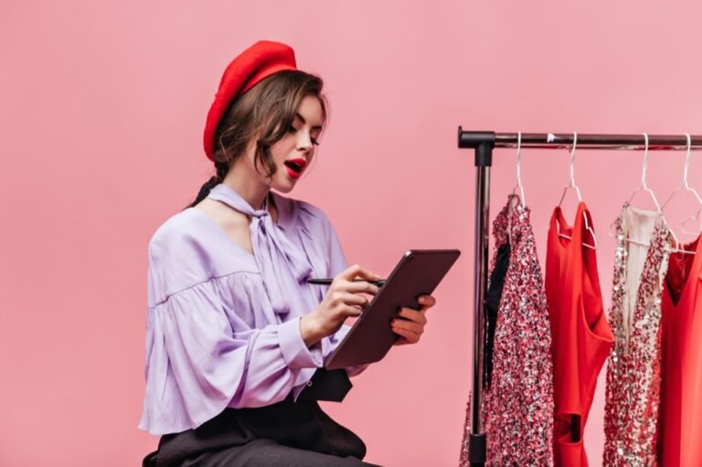Reviewer taking notes next to a clothes rail