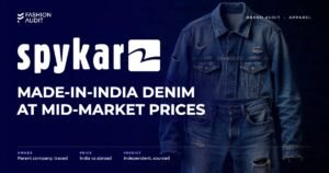 Spykar brand audit by FashionAudit: Spykar logo and the headline “Made-in-India Denim at Mid-Market Prices” over distressed denim jeans and a denim jacket on a brick wall background