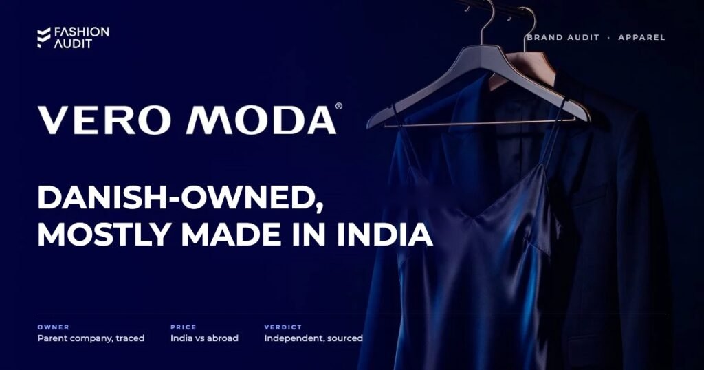 Vero Moda brand audit by FashionAudit: Vero Moda logo and the headline “Danish-Owned, Mostly Made in India” over a satin slip dress and a tailored blazer on a chic boutique hanger