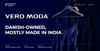 Vero Moda brand audit by FashionAudit: Vero Moda logo and the headline “Danish-Owned, Mostly Made in India” over a satin slip dress and a tailored blazer on a chic boutique hanger